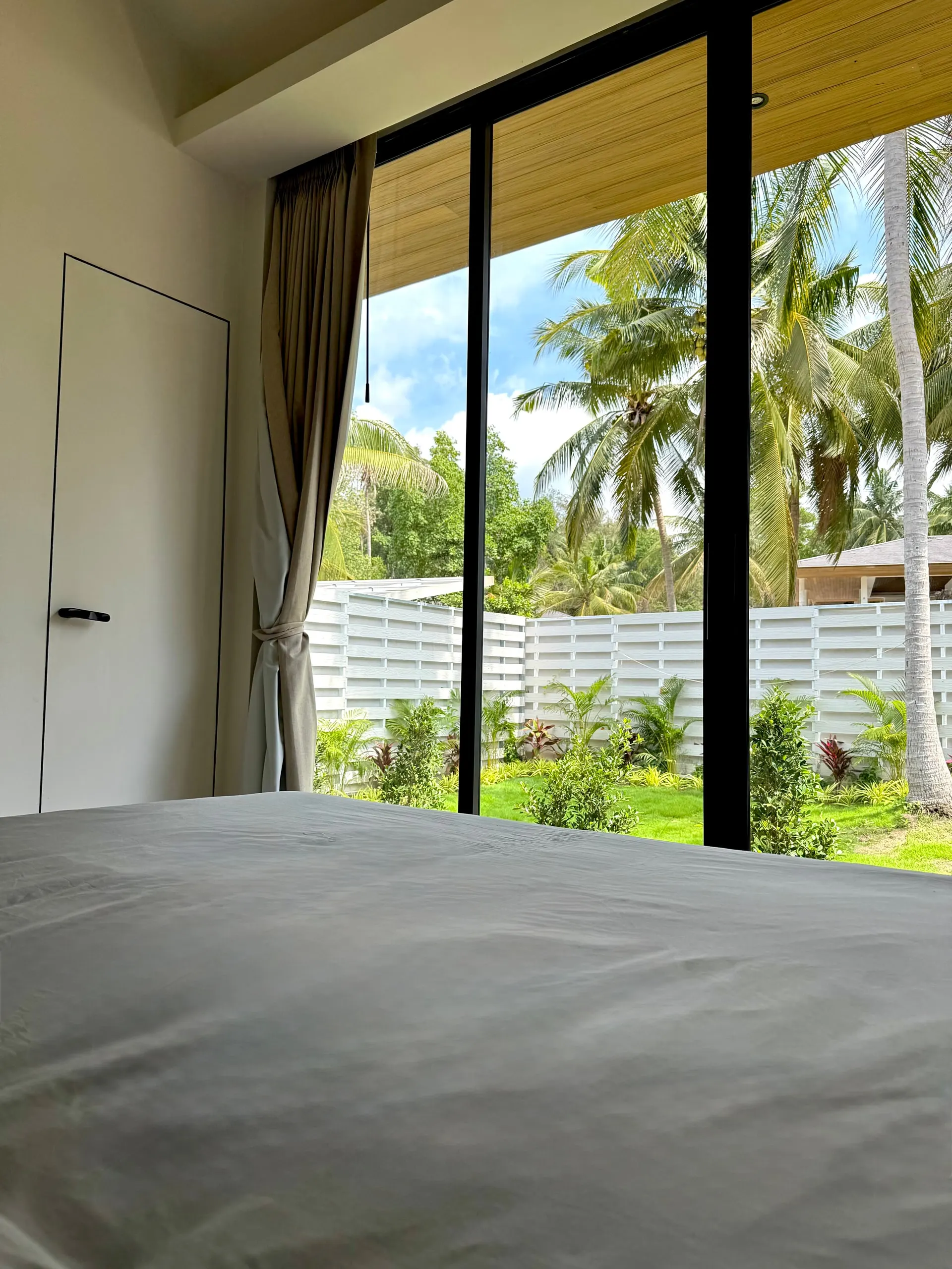 Villa I — garden view from the foot of the bed in bedroom one