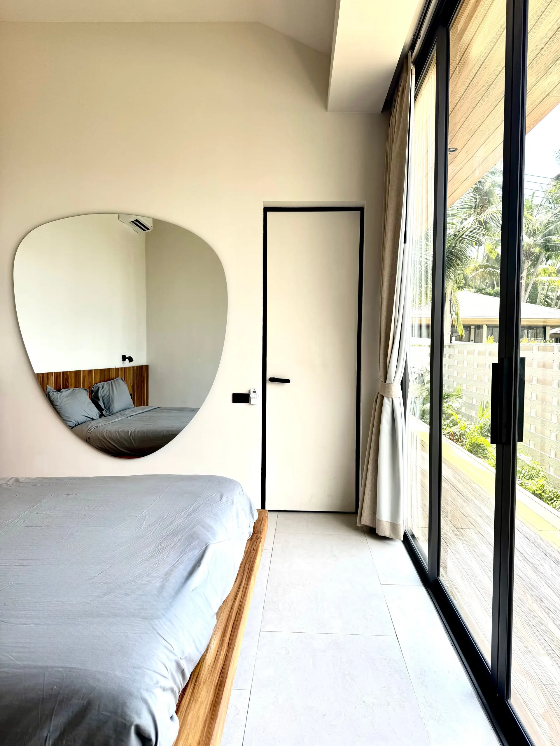 Villa I — bedroom two corner with asymmetric mirror and sliding glass
