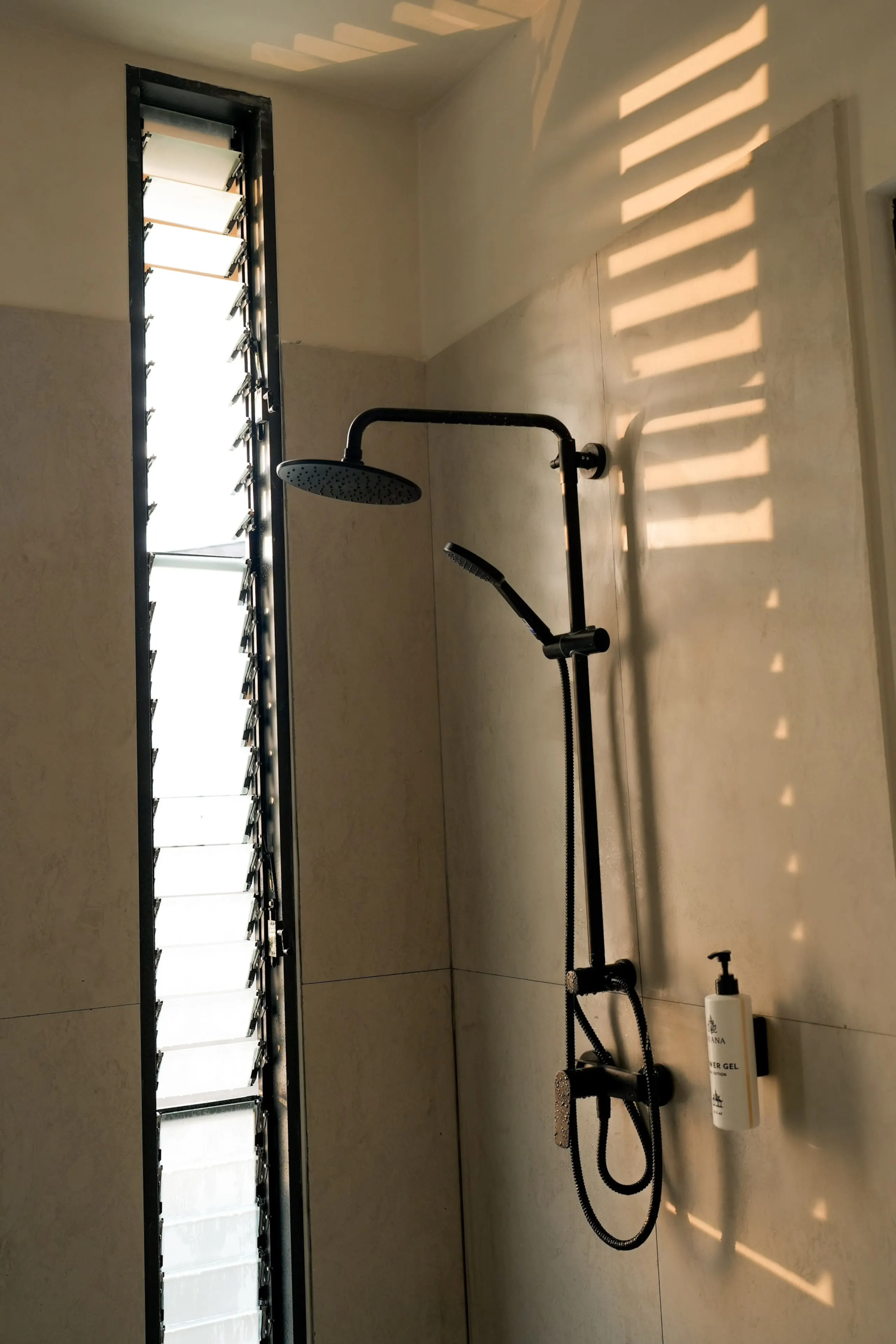 Villa II — bathroom one, natural stone basin and rain shower