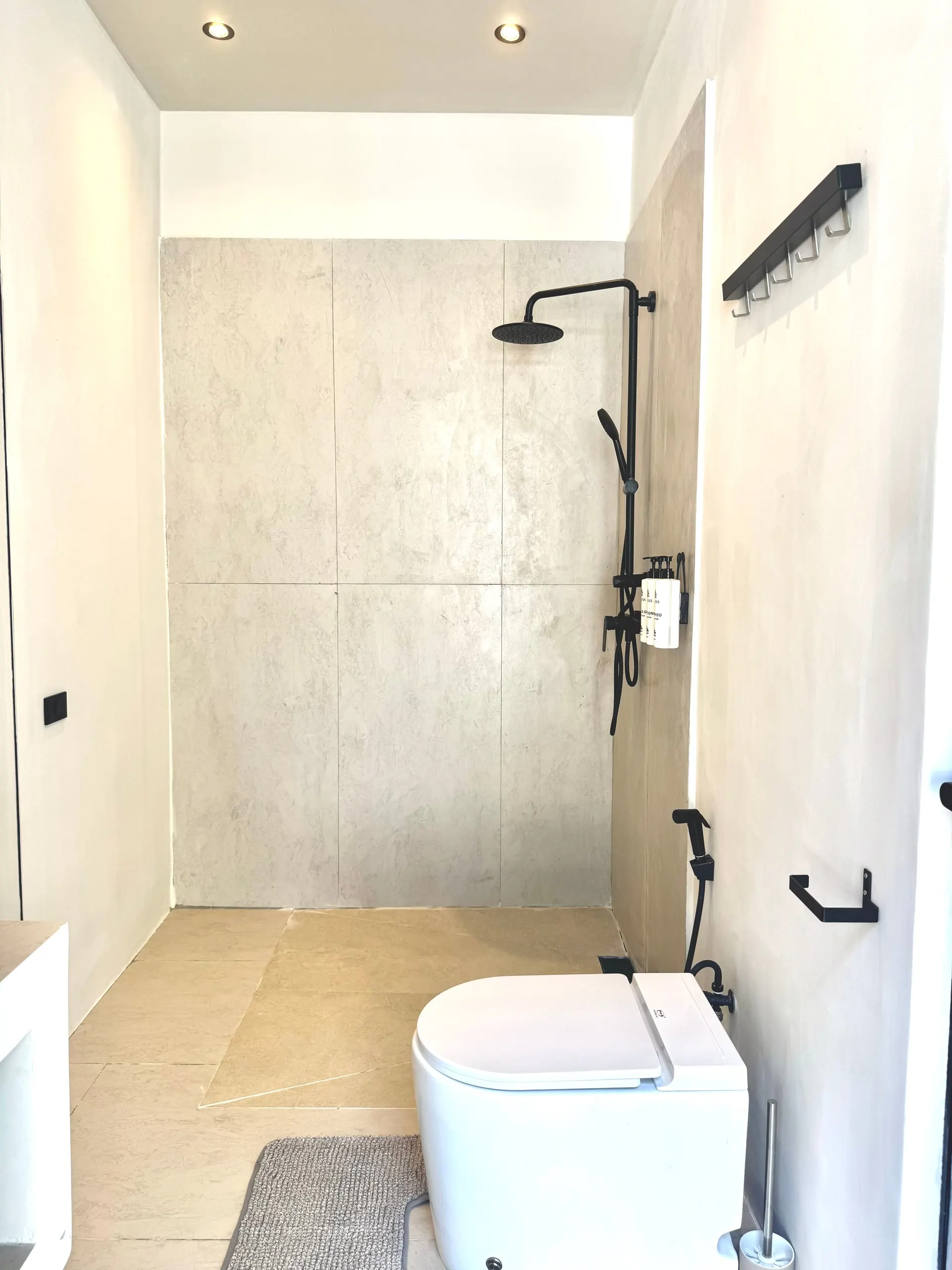 Villa II — bathroom two, open stone-clad shower zone