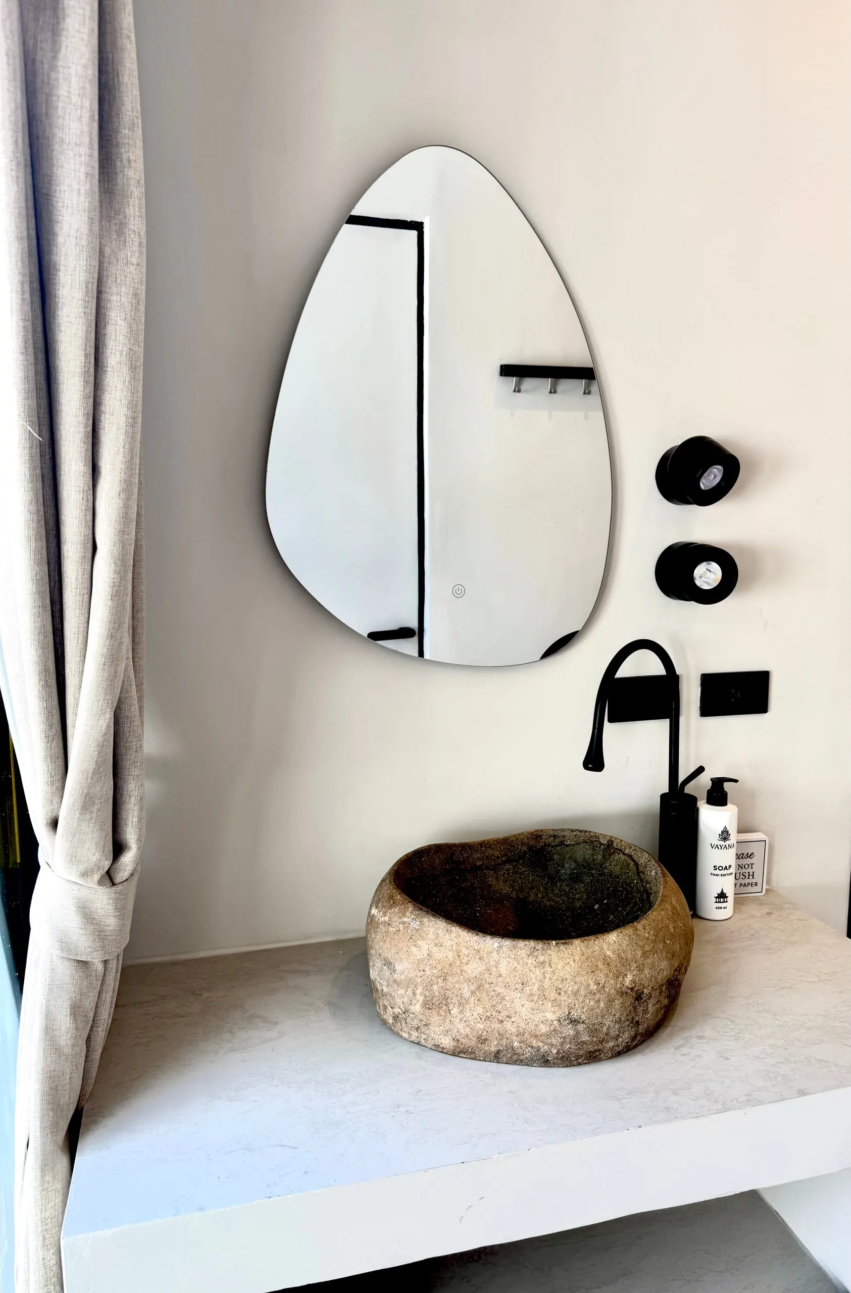 Villa II — bathroom two, teardrop mirror and stone basin