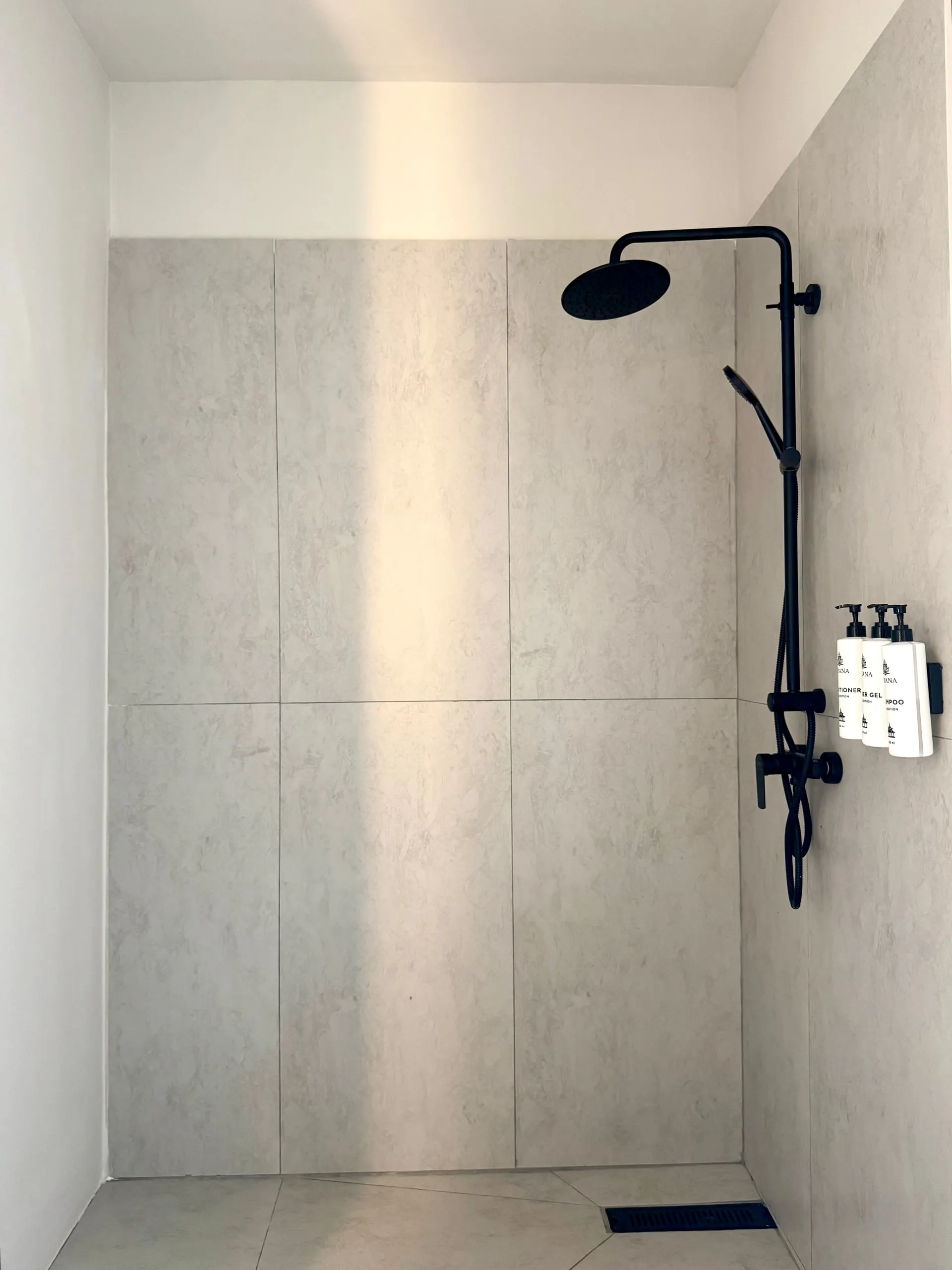 Villa I — walk-in rain shower in grey marble tile