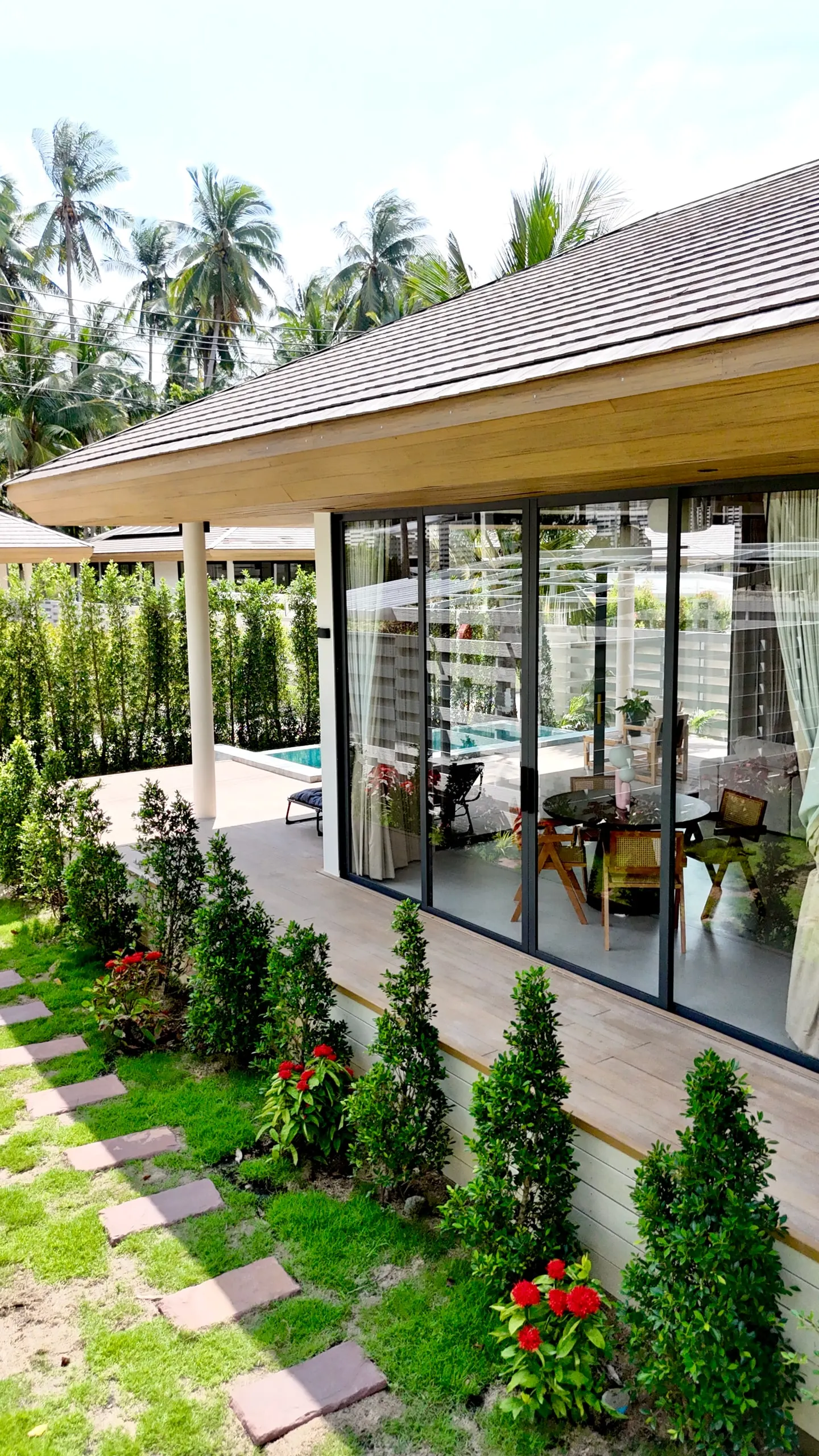 Villa I — villa corner with pool reflections and red ixora
